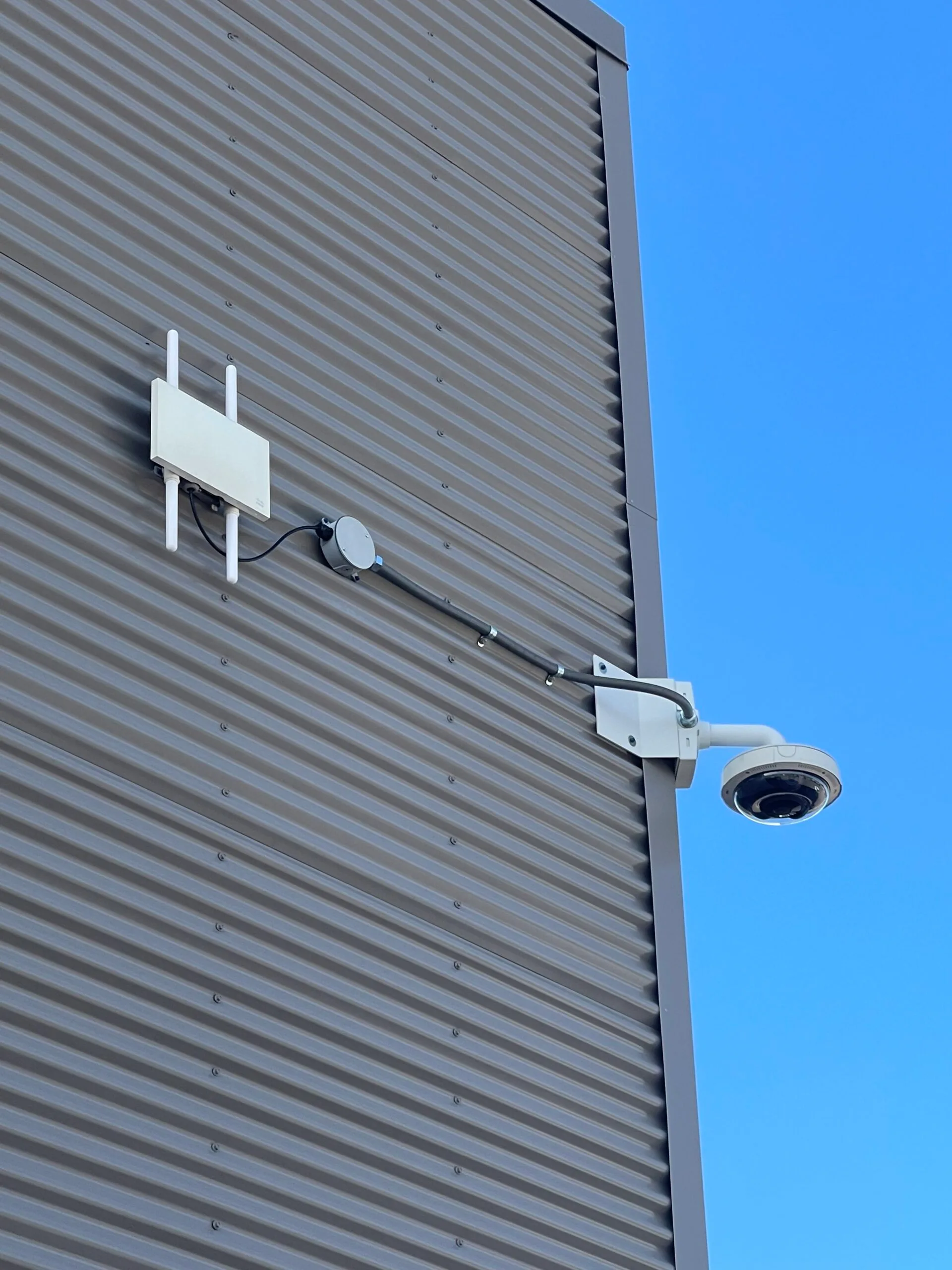 Corner-mounted multi-lens camera with exterior Wi-Fi access point