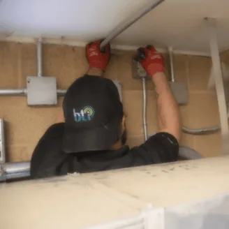 BTI technician installing professional IT, VoIP, and physical security services near you