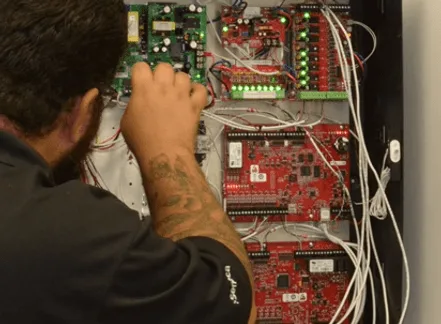 BTI technician troubleshooting a door access control system
