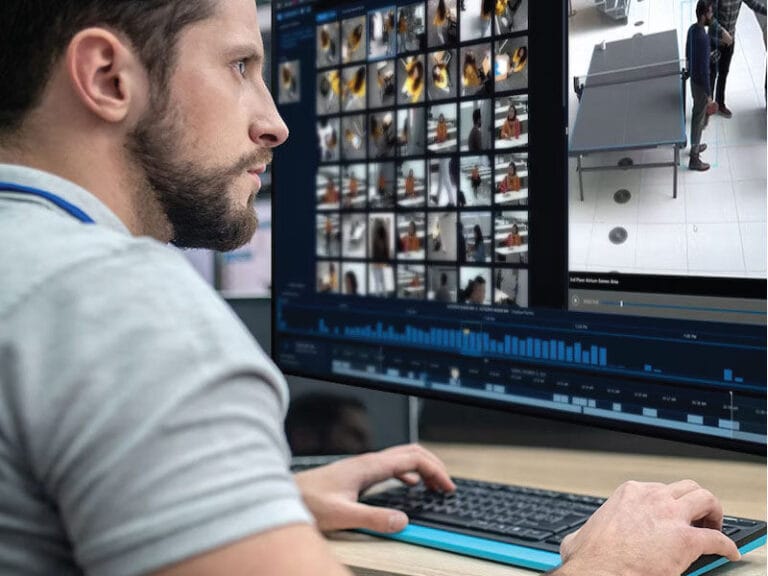 Security Manager managing integrated security systems on his computer.