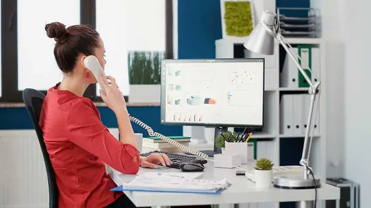 Female employee answering a phone call.