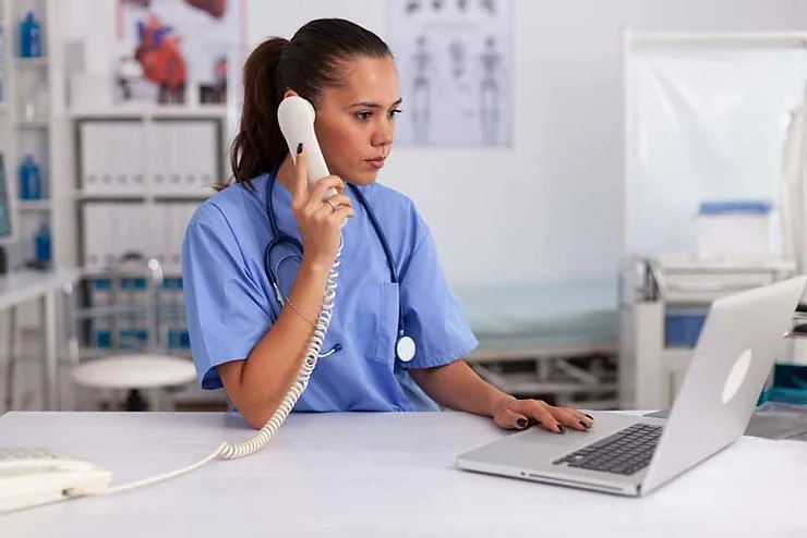 Medical practitioner answering a phone call.