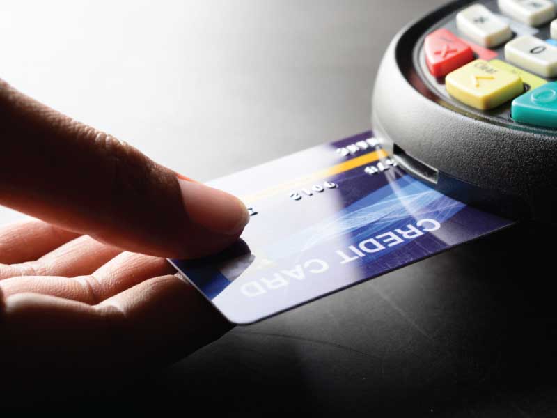 Person making a credit card payment in a PCI compliant POS system.