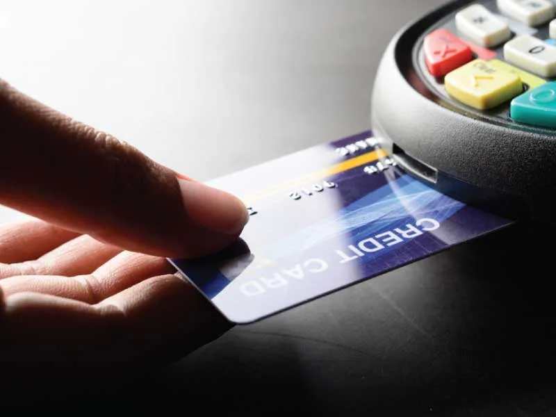 Person making a credit card payment in a PCI compliant POS system.