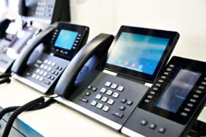 Row of business desk phones with color touchscreen displays