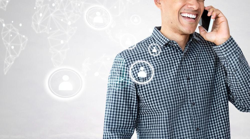 Smiling caller on a mobile phone whose call is answered and routed by an AI receptionist