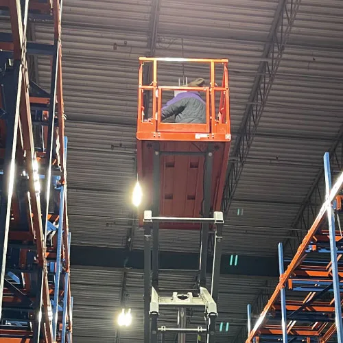 BTI technician installing commercial wifi in a warehouse