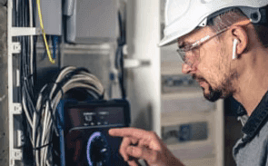 Technician organizing structured network cabling for business IT infrastructure