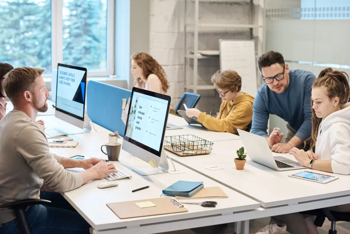 Business team reviewing AI sales and marketing alignment strategy in an office